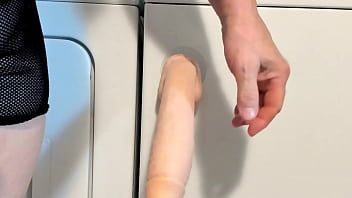 Play Fuck my new 12 inches dildo while in a chastity cage.
